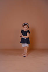 Baby Girl Black Striped Top with White Bow and Shorts – Stylish Kids Outfit Se